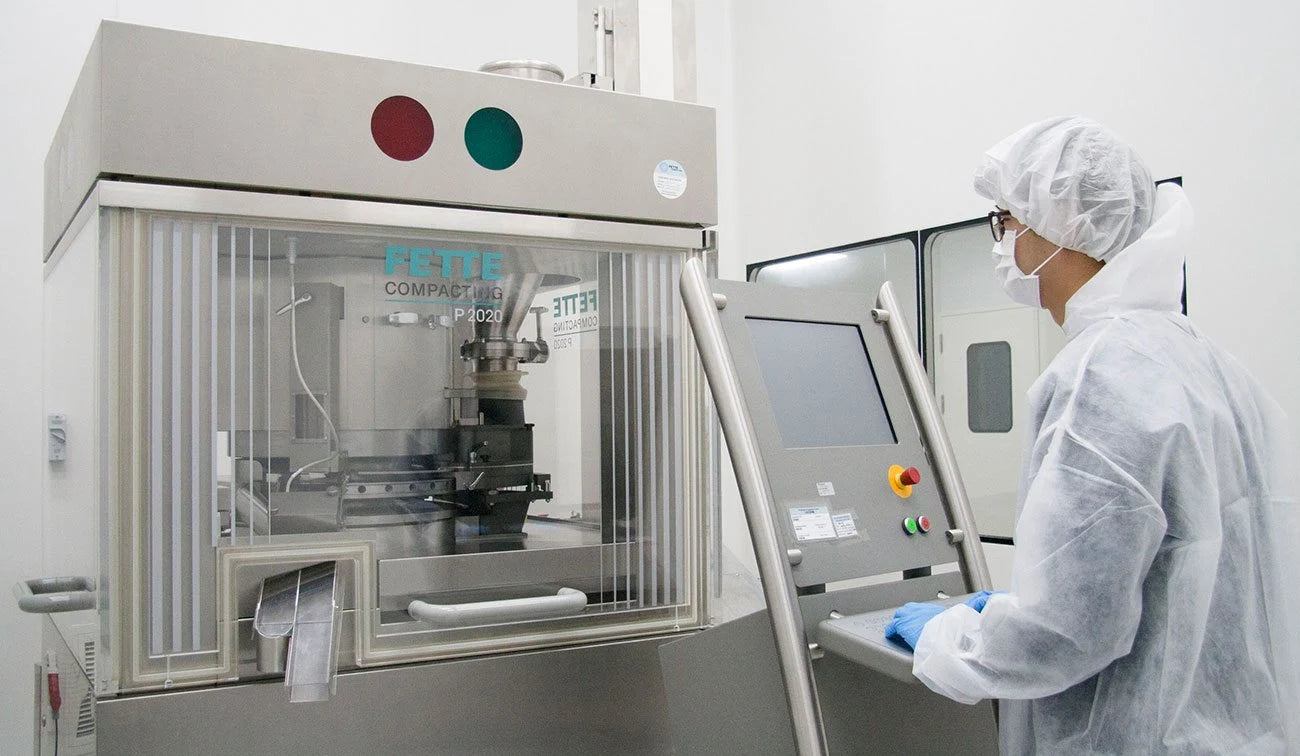 Production operator working with equipment in the company manufacturing facility
